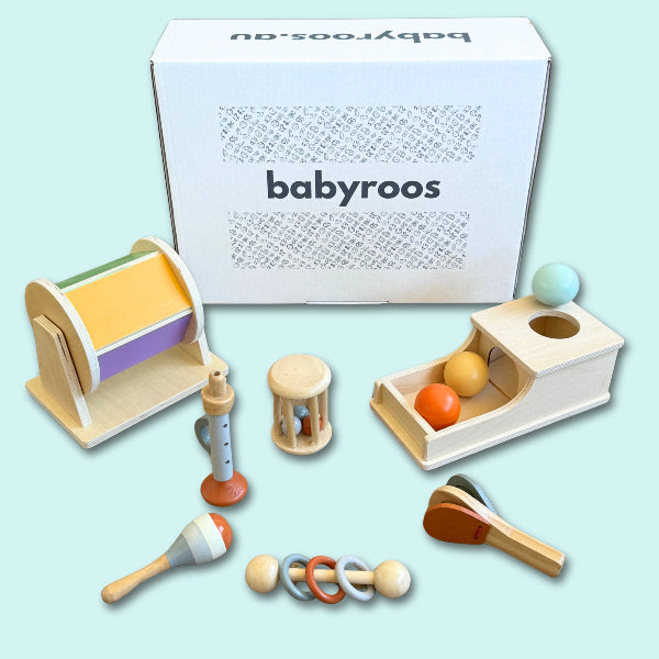 Babyroos Montessori toy box with wooden rattles, spinning drum, ball drop toy box, pounding ball set and pastel maracas – ideal for 6–12 month fine motor development