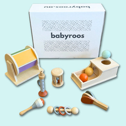 Babyroos Montessori toy box with wooden rattles, spinning drum, ball drop toy box, pounding ball set and pastel maracas – ideal for 6–12 month fine motor development