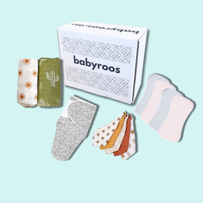 abyroos newborn essentials box featuring muslin wraps, adjustable swaddle, burp cloths and cotton bibs in neutral tones – perfect for gifting and daily baby care